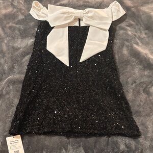 Cider Black Sequin dress with White Bow in back. Never been worn.